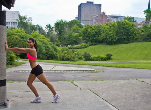 Young woman stretches before running