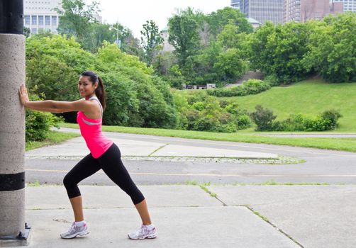 Young woman stretches before running