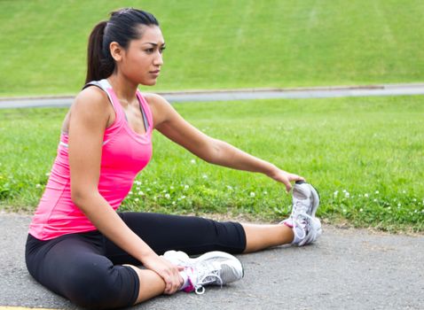 Young woman stretches before running