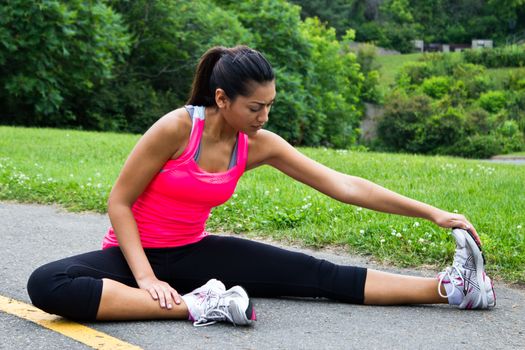 Young woman stretches before running