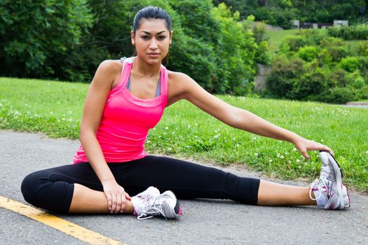 Young woman stretches before jogging
