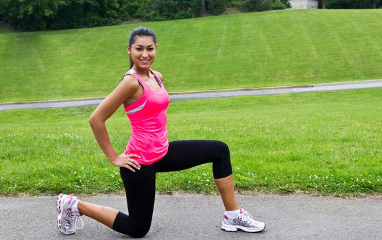 Young woman stretching before a run