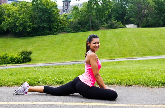 Young woman stretching before a jog