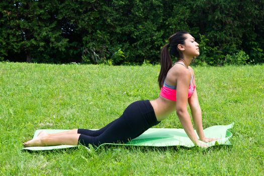 Young woman doing yoga in the park