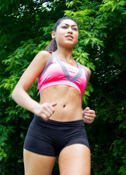 Young, atractive woman running on the nature trail