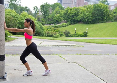 Young woman stretches before running