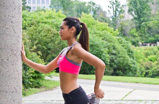 Young woman stretches before running