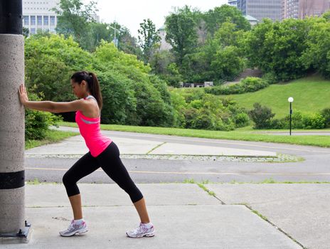 Young woman stretches before running