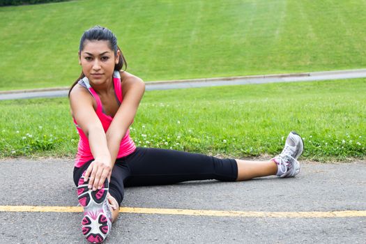 Young woman stretches before jogging