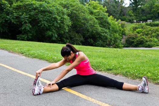 Young woman stretches before running