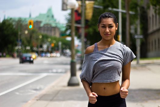 Fit young woman running on a busy city street