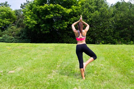 Young woman doing yoga in the park