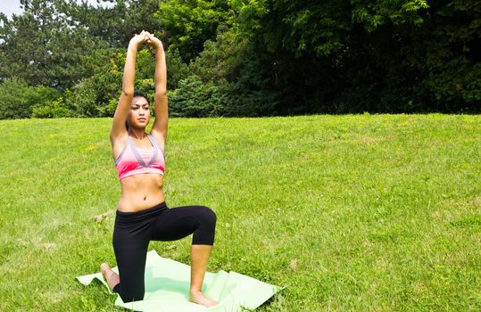 Young woman doing yoga in the park