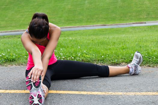 Young woman stretches before running