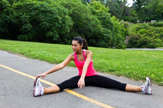 Young woman stretching before a run