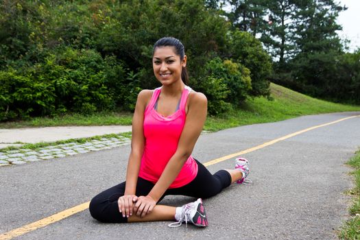 Young woman stretching before a run