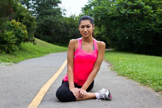 Young woman stretching before a jog