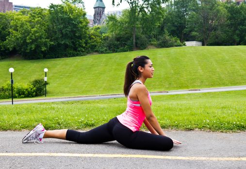 Young woman stretching before a run