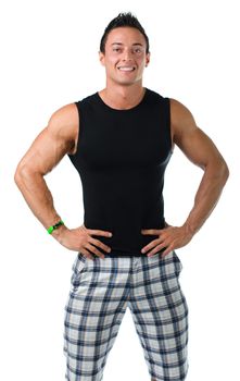 Attractive young muscle man in black tank top smiling with hands on his hips, isolated