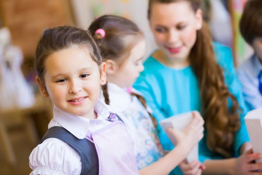 Little children painting and playing at kindergarten