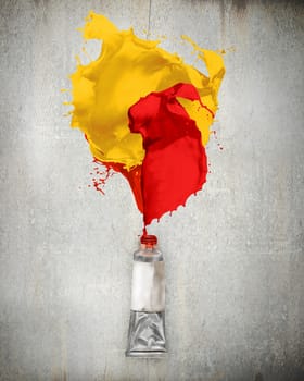 Image of paint tube with color splashes