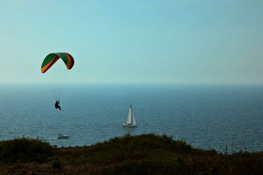 Parachute flying above the sea . Israel .