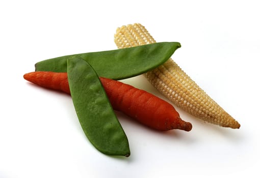 Corn, carrot and green peas on the white background