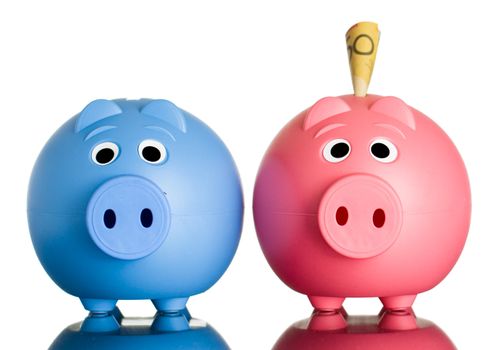 Two cute piggy banks with Australian dollars in one of them. Isolated on white.