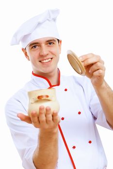 Young cook preparing food wearing a red apron