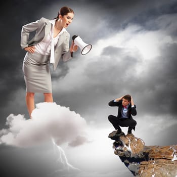 Angry businesswoman with megaphone shouting at colleague