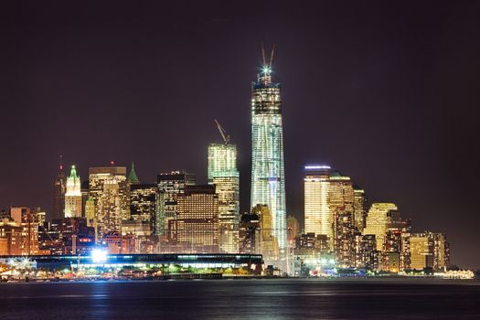 New York City skyline at night w the Freedom tower under construction