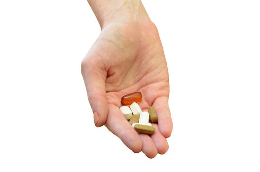 hand holding daily vitamins or medicine on white