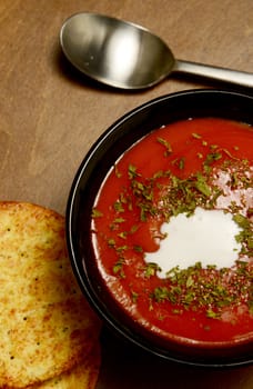 creamy tomato soup on a dark wood table