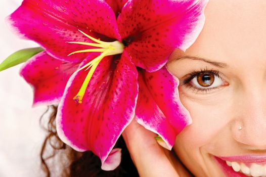 Close up of a woman's eye and flower in her hair