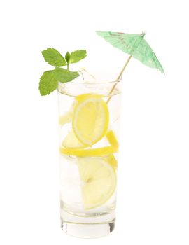 Full glass of water with lemon and mint. Close up. White background.