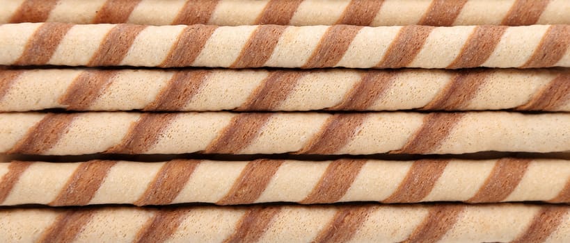 Background of waffle rolls. Close up. Horizontal.