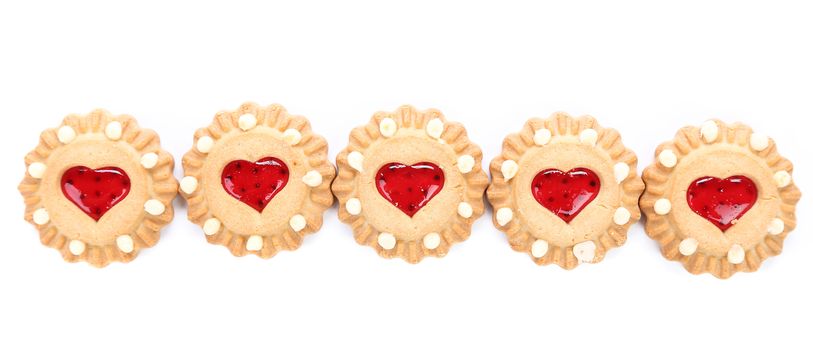 Row heart shaped strawberry biscuit. White background.