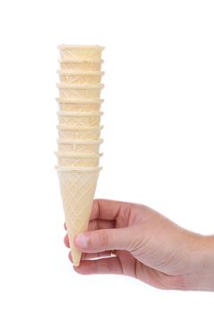 Hand hold stake of ice cream cones. White background.