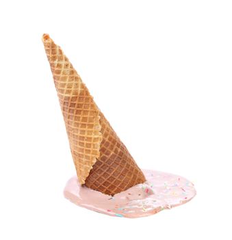 Chocolate ice cream cone fallen onto a white surface. Isolated.