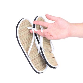 Pair of striped flip-flop sandals in hand. White background.