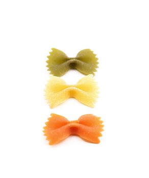 Farfalle pasta, isolated, three colors. White background.