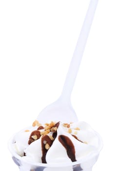 Spoon into ice cream with chocolate topic and nuts. White background.