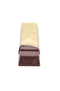 Bar of chocolate in gold foil. White background.