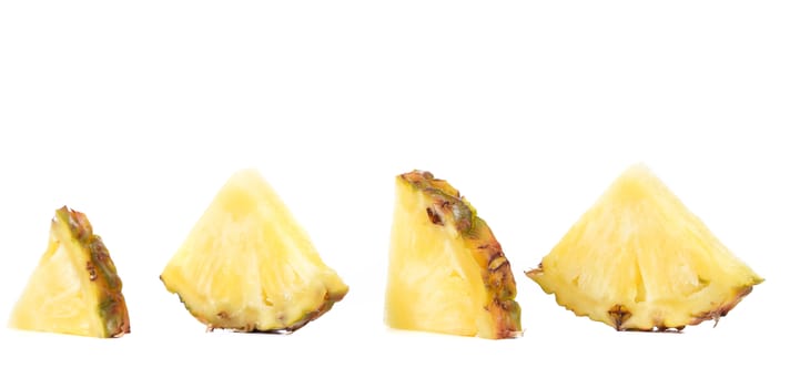 Quarters of slices pineapple on a white background.