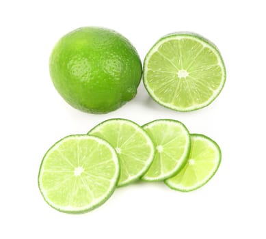 Fresh lime and slices. Close up. White background.