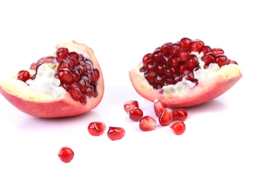 Slices and seeds pomegranate. Close up. White background.