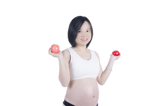 pregnant woman holding fruit