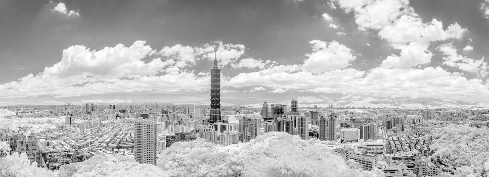 Taipei cityscape with dramatic clouds at sky, infrared photography in black and white.
