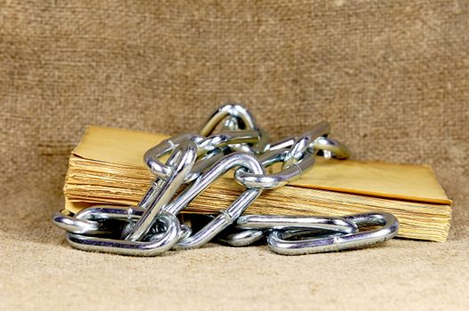 old book surrounded with chain