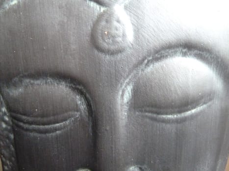 Sleeping Buddha design on a ceramic object